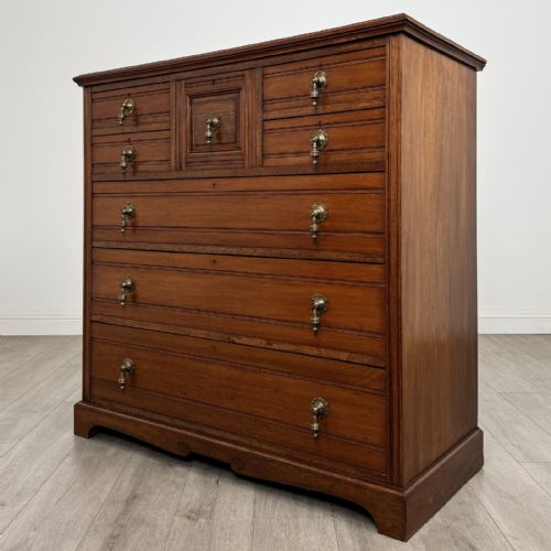 fig 1. A late Victorian walnut chest of drawers featuring a central square hat drawer flanked by smaller drawers above three long drawers with reeded moulding.