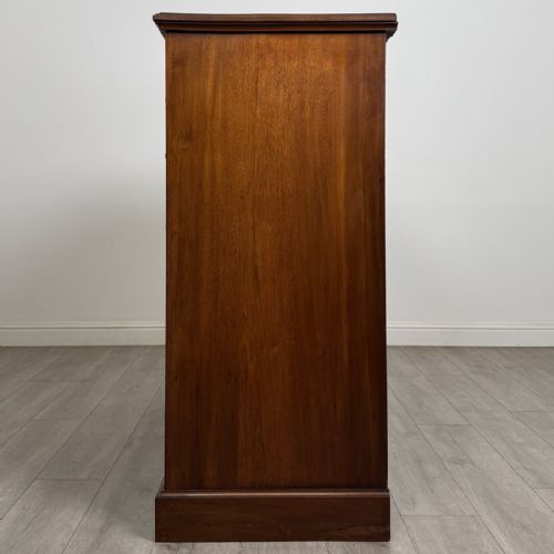 fig 2. A late Victorian walnut chest of drawers featuring a central square hat drawer flanked by smaller drawers above three long drawers with reeded moulding.