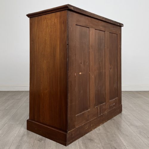 fig 3. A late Victorian walnut chest of drawers featuring a central square hat drawer flanked by smaller drawers above three long drawers with reeded moulding.