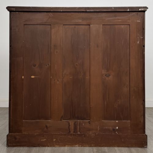 fig 4. A late Victorian walnut chest of drawers featuring a central square hat drawer flanked by smaller drawers above three long drawers with reeded moulding.