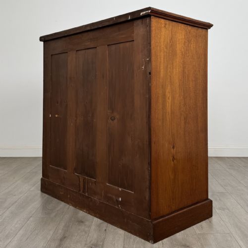 fig 5. A late Victorian walnut chest of drawers featuring a central square hat drawer flanked by smaller drawers above three long drawers with reeded moulding.