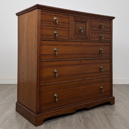 fig 7. A late Victorian walnut chest of drawers featuring a central square hat drawer flanked by smaller drawers above three long drawers with reeded moulding.