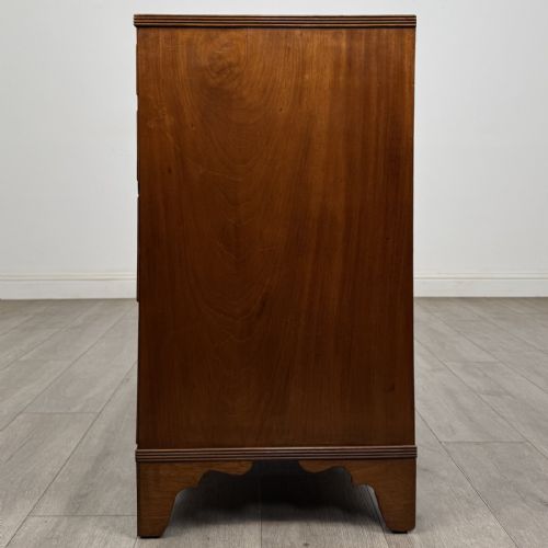 fig 2. A straight-front Georgian style mahogany chest features four full-width drawers with decorative oval brass drop handles, keyhole escutcheons, and bracket feet.