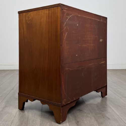 fig 3. A straight-front Georgian style mahogany chest features four full-width drawers with decorative oval brass drop handles, keyhole escutcheons, and bracket feet.