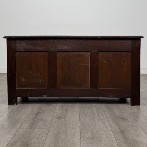 fig 4. A dark oak Jacobean style blanket box featuring a carved lunette frieze, three panelled sections, and guilloche carving along the stiles.