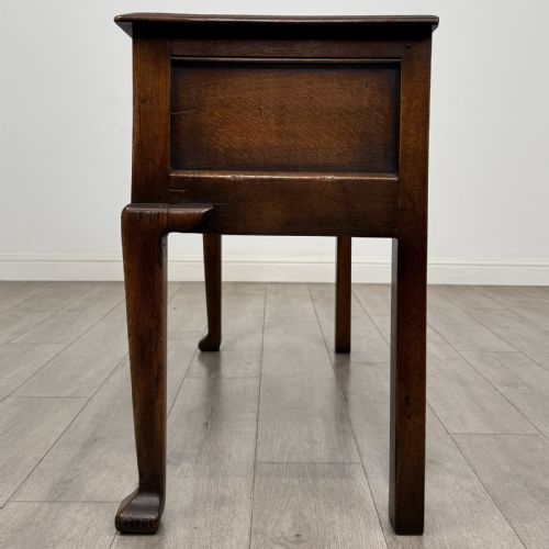 fig 2. A Georgian style dark oak dresser base featuring three drawers with brass swan-neck handles, a shaped apron, and cabriole front legs.