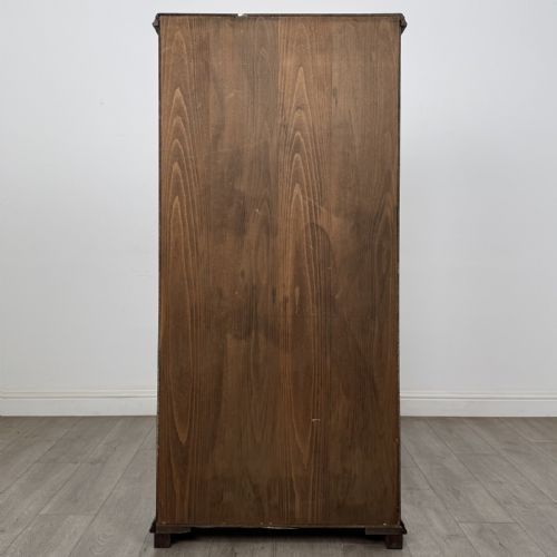 fig 5. A tall dark oak open bookcase with five tiered compartments, adjustable shelves, a moulded cornice, and flattened bun feet.