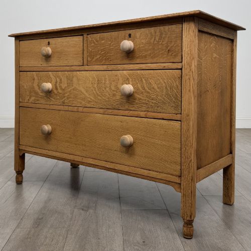 fig 1. An Edwardian quarter-sawn oak chest of drawers with two short drawers over two long drawers and turned wooden handles.