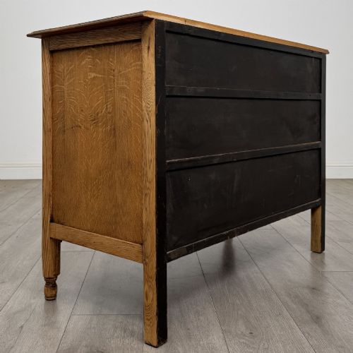 fig 3. An Edwardian quarter-sawn oak chest of drawers with two short drawers over two long drawers and turned wooden handles.