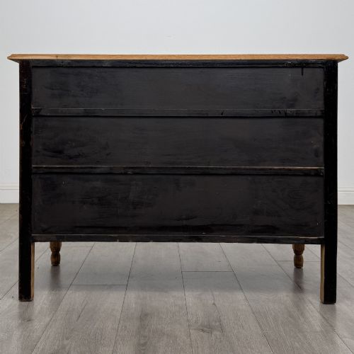 fig 4. An Edwardian quarter-sawn oak chest of drawers with two short drawers over two long drawers and turned wooden handles.