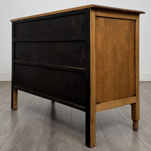 fig 5. An Edwardian quarter-sawn oak chest of drawers with two short drawers over two long drawers and turned wooden handles.