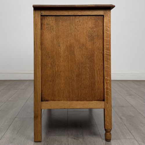fig 6. An Edwardian quarter-sawn oak chest of drawers with two short drawers over two long drawers and turned wooden handles.