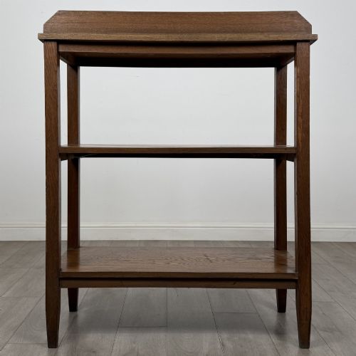 fig 4. An antique Edwardian dark oak buffet featuring three open rectangular shelves supported by straight tapered legs.