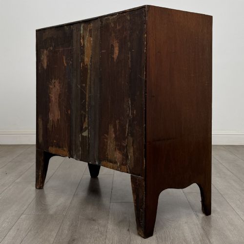 fig 5. A 19th-century dark mahogany bow front chest of drawers featuring two short drawers above two long drawers with turned wooden handles and bracket feet.