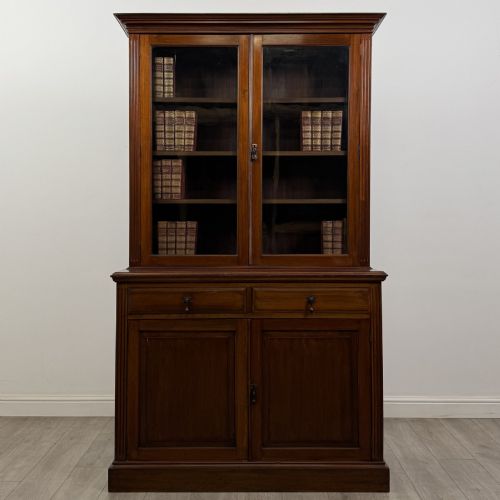 fig 1. An antique Victorian mahogany glazed bookcase featuring two upper glass doors, twin frieze drawers, and lower panelled doors.
