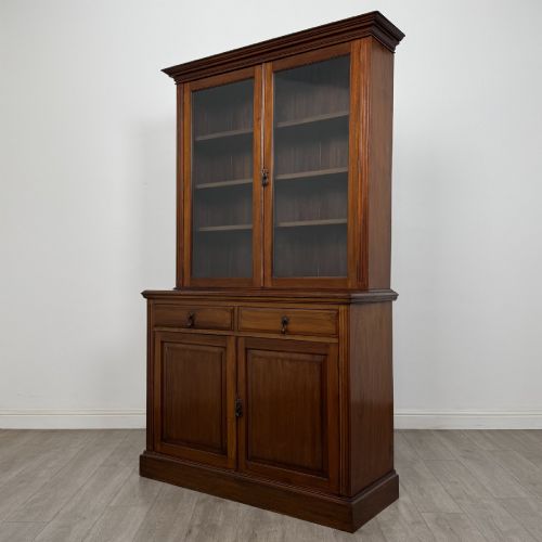 fig 2. An antique Victorian mahogany glazed bookcase featuring two upper glass doors, twin frieze drawers, and lower panelled doors.