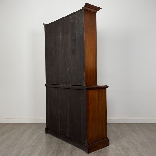 fig 6. An antique Victorian mahogany glazed bookcase featuring two upper glass doors, twin frieze drawers, and lower panelled doors.