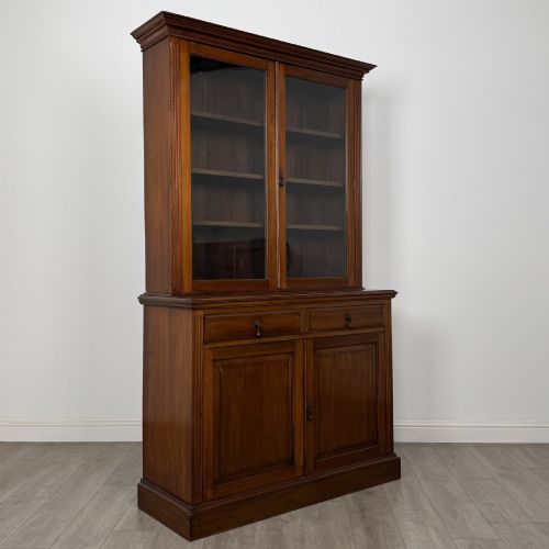 fig 8. An antique Victorian mahogany glazed bookcase featuring two upper glass doors, twin frieze drawers, and lower panelled doors.