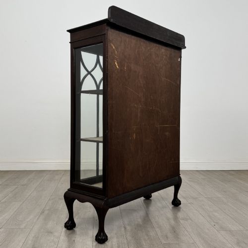 fig 3. A dark mahogany display cabinet featuring two glazed doors with geometric arch bars and carved ball-and-claw feet.