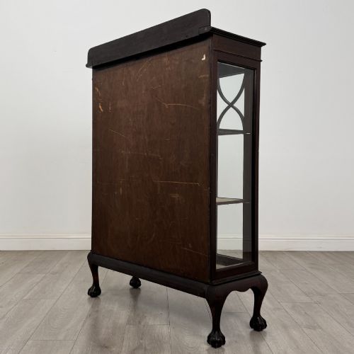 fig 5. A dark mahogany display cabinet featuring two glazed doors with geometric arch bars and carved ball-and-claw feet.