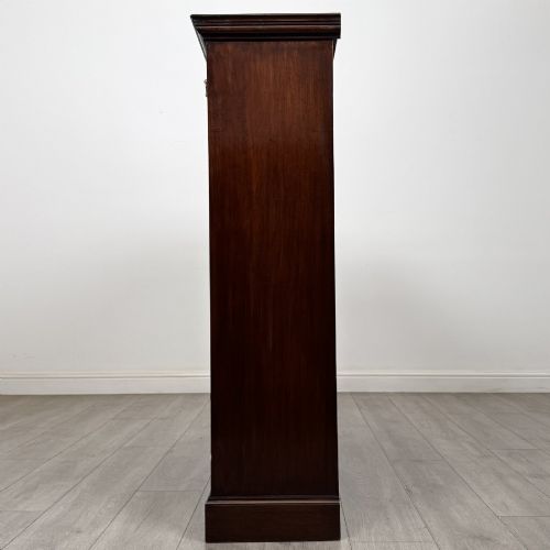 fig 3. An Edwardian dark mahogany open bookcase featuring three frieze drawers with brass drop handles and three adjustable wooden shelves above a plinth base.