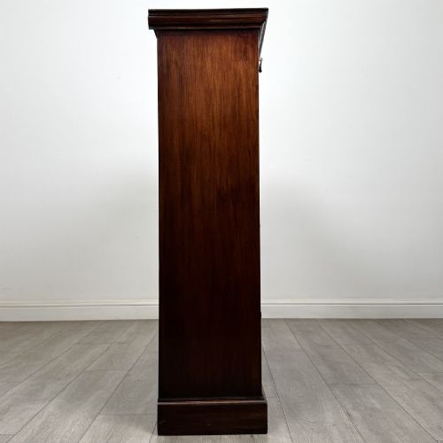 fig 7. An Edwardian dark mahogany open bookcase featuring three frieze drawers with brass drop handles and three adjustable wooden shelves above a plinth base.