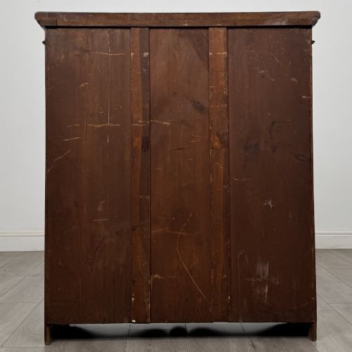 fig 5. A dark brown Victorian pine open bookcase featuring adjustable shelving, reeded side pilasters, and a shaped apron at the base.