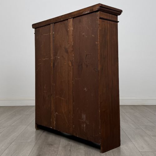 fig 6. A dark brown Victorian pine open bookcase featuring adjustable shelving, reeded side pilasters, and a shaped apron at the base.