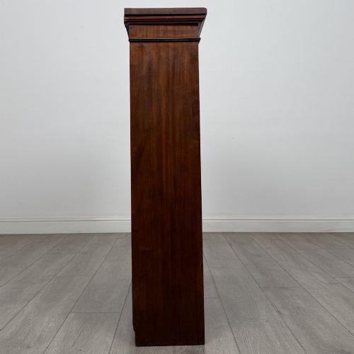 fig 7. A dark brown Victorian pine open bookcase featuring adjustable shelving, reeded side pilasters, and a shaped apron at the base.