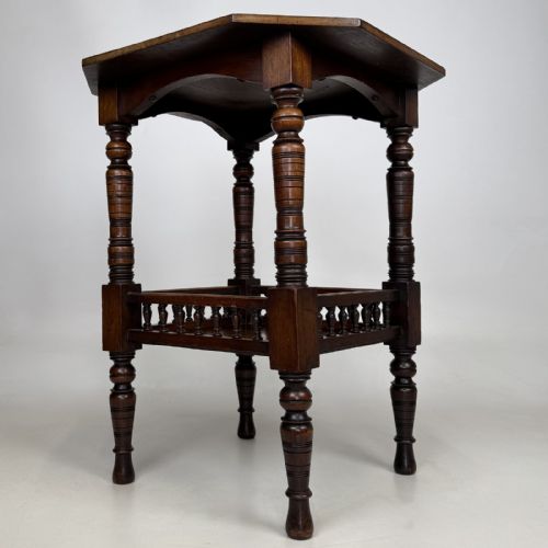 fig 1. A dark walnut Victorian Aesthetic side table featuring an octagonal top, turned legs, and a lower shelf enclosed by a turned spindle gallery.
