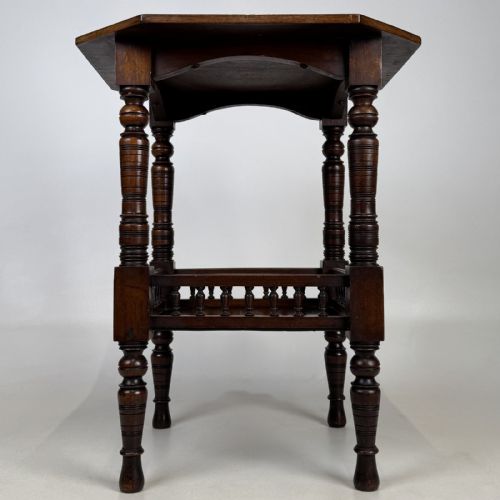 fig 2. A dark walnut Victorian Aesthetic side table featuring an octagonal top, turned legs, and a lower shelf enclosed by a turned spindle gallery.