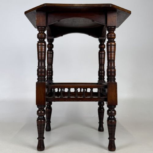 fig 4. A dark walnut Victorian Aesthetic side table featuring an octagonal top, turned legs, and a lower shelf enclosed by a turned spindle gallery.