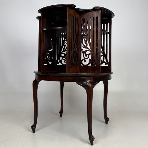 fig 1. An Edwardian dark mahogany revolving bookcase with pierced foliage fretwork side panels and cabriole legs.