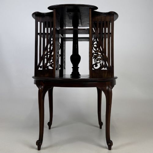 fig 4. An Edwardian dark mahogany revolving bookcase with pierced foliage fretwork side panels and cabriole legs.
