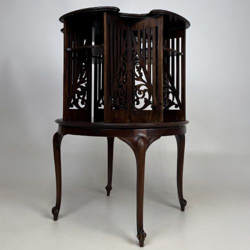 fig 5. An Edwardian dark mahogany revolving bookcase with pierced foliage fretwork side panels and cabriole legs.