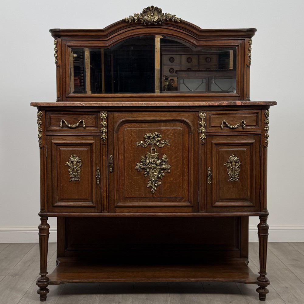 A pair of 19th-century French dark wood cabinets featuring pink marble tops, mirrored upper backs, gilded metal mounts, and lower open shelves. View II