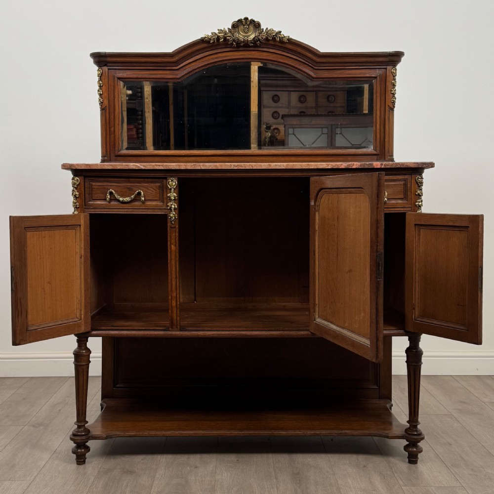 A pair of 19th-century French dark wood cabinets featuring pink marble tops, mirrored upper backs, gilded metal mounts, and lower open shelves. View III