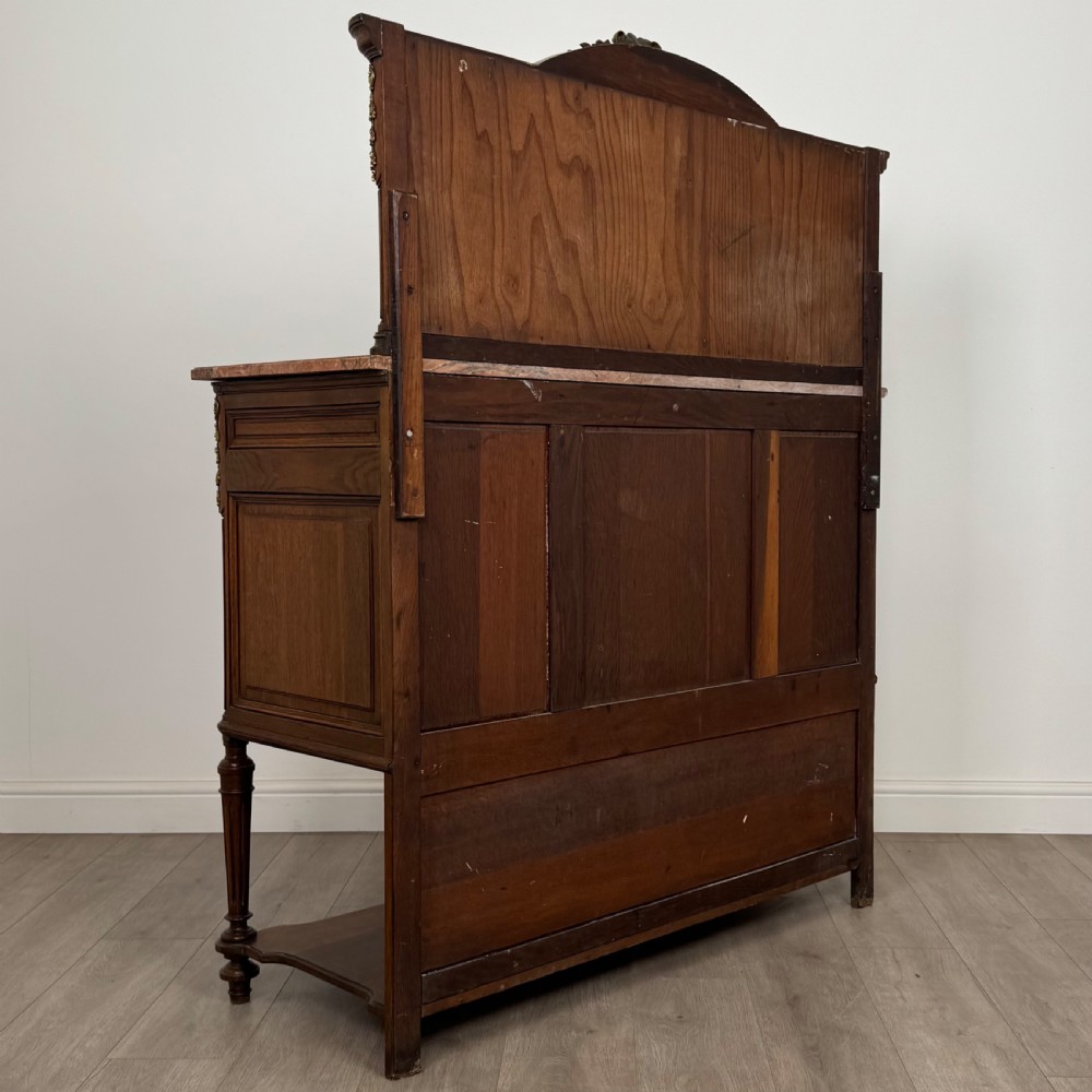 A pair of 19th-century French dark wood cabinets featuring pink marble tops, mirrored upper backs, gilded metal mounts, and lower open shelves. View VI