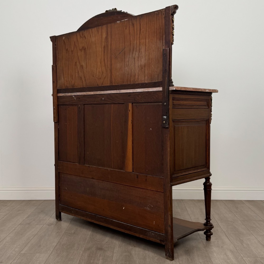 A pair of 19th-century French dark wood cabinets featuring pink marble tops, mirrored upper backs, gilded metal mounts, and lower open shelves. View VIII