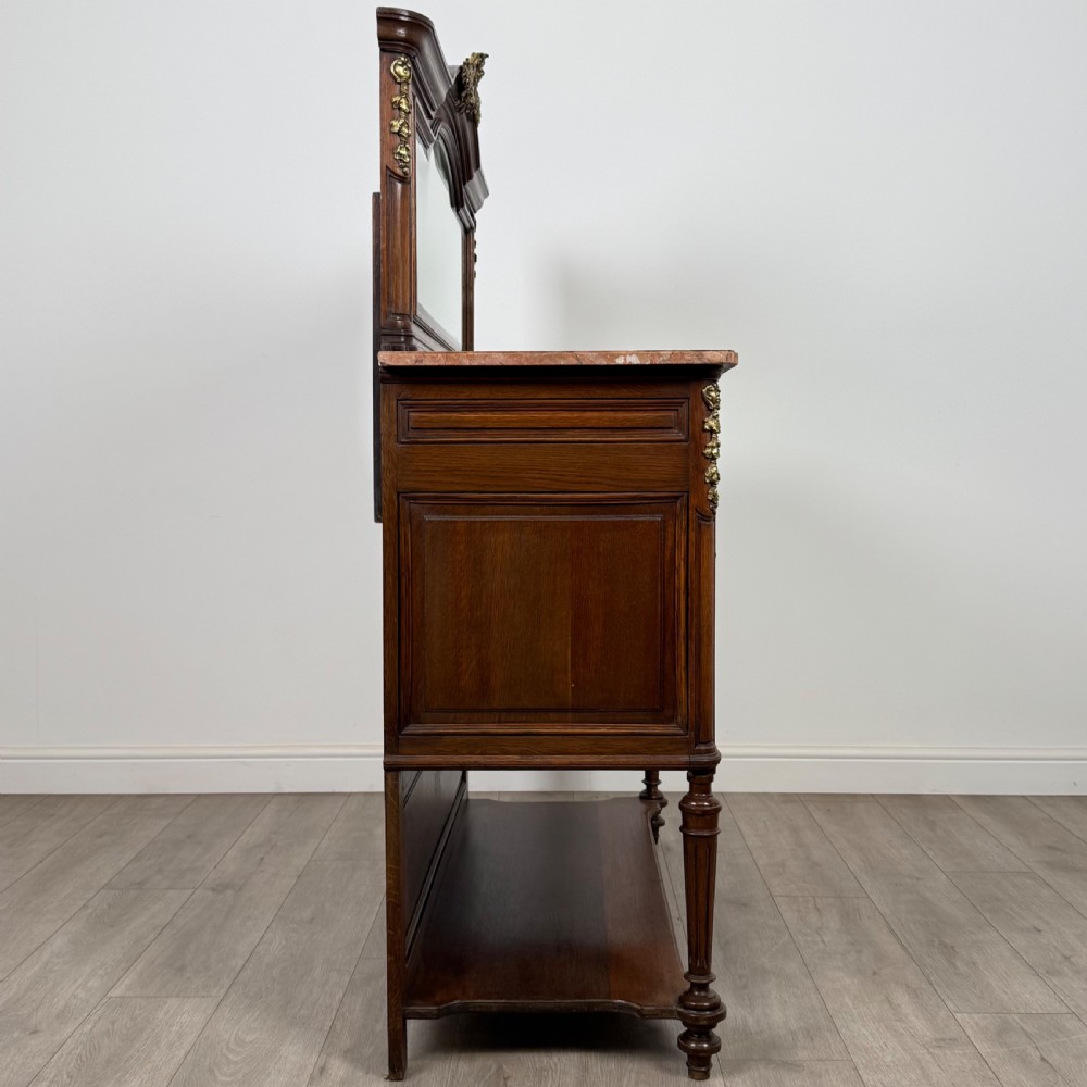 A pair of 19th-century French dark wood cabinets featuring pink marble tops, mirrored upper backs, gilded metal mounts, and lower open shelves. View IX