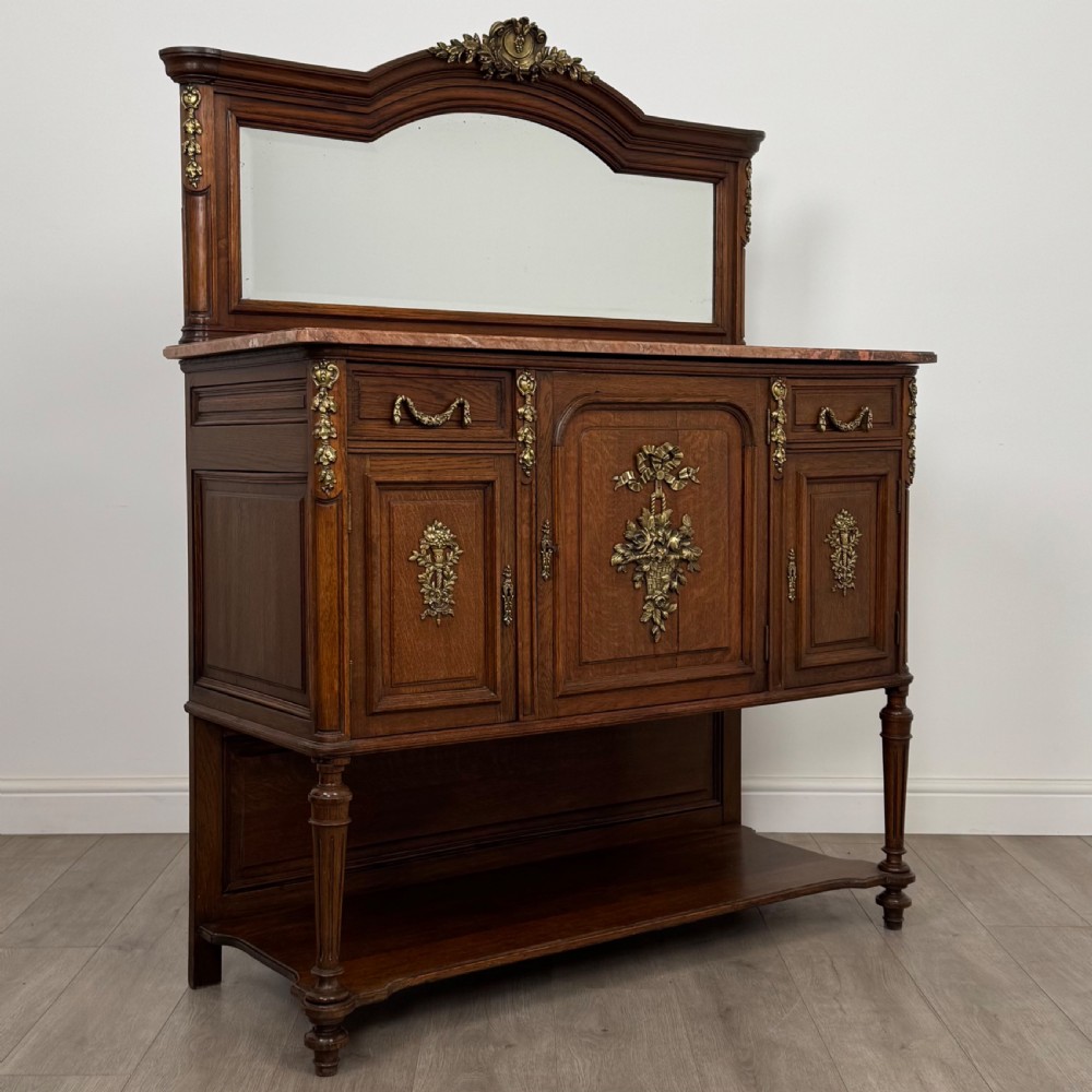 A pair of 19th-century French dark wood cabinets featuring pink marble tops, mirrored upper backs, gilded metal mounts, and lower open shelves. View X
