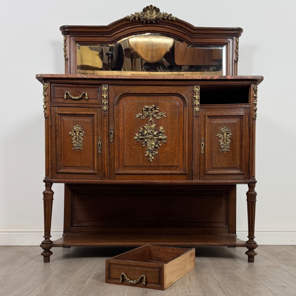 A pair of 19th-century French dark wood cabinets featuring pink marble tops, mirrored upper backs, gilded metal mounts, and lower open shelves. View XIII