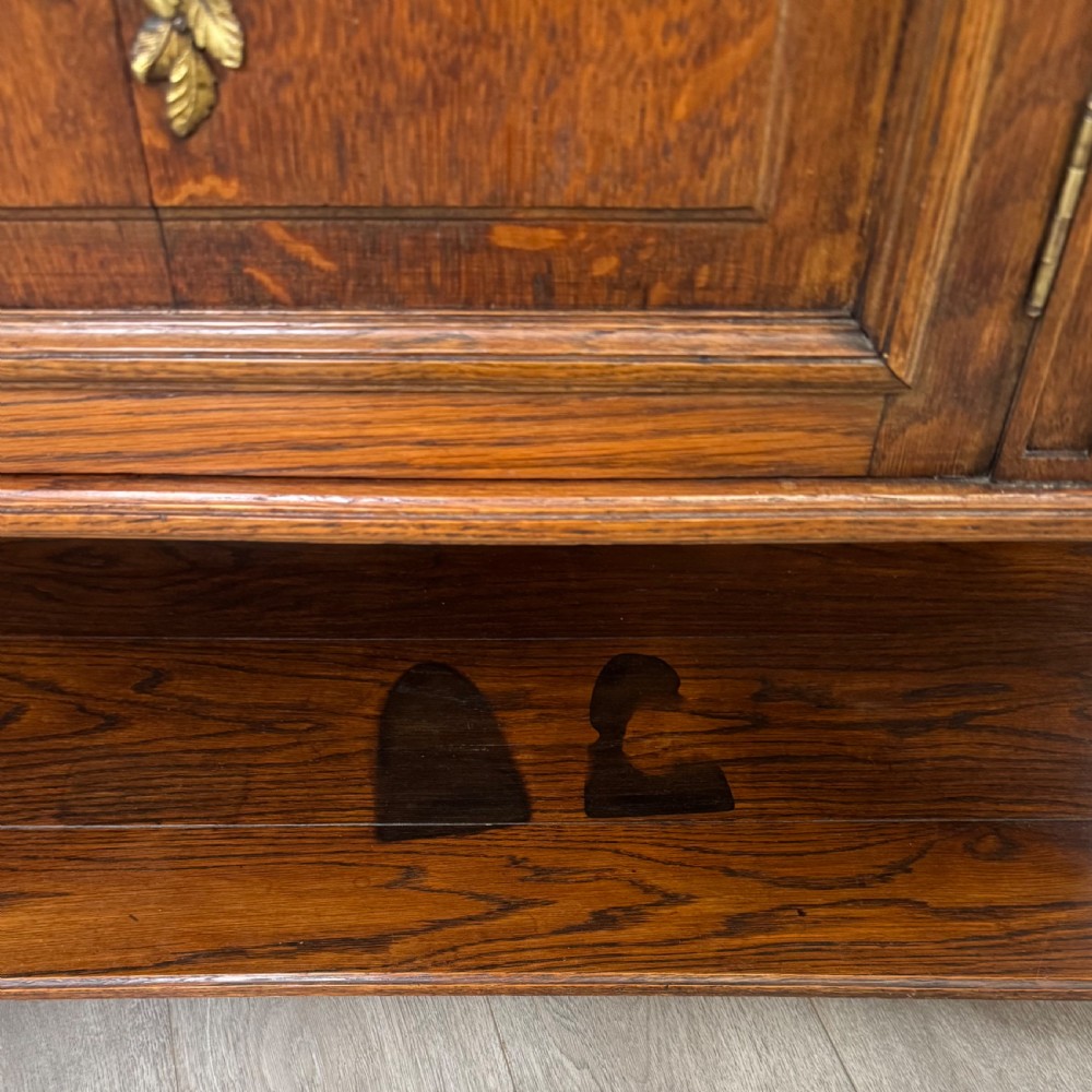 A pair of 19th-century French dark wood cabinets featuring pink marble tops, mirrored upper backs, gilded metal mounts, and lower open shelves. View XVI