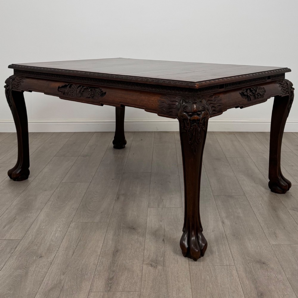 A dark carved rosewood dining suite featuring a rectangular table with carved cabriole legs accompanied by six splat-back chairs including two armchairs. View II