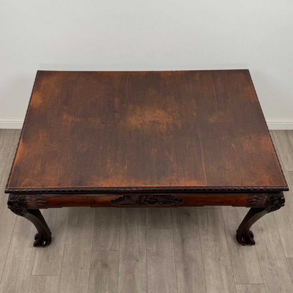 A dark carved rosewood dining suite featuring a rectangular table with carved cabriole legs accompanied by six splat-back chairs including two armchairs. View V