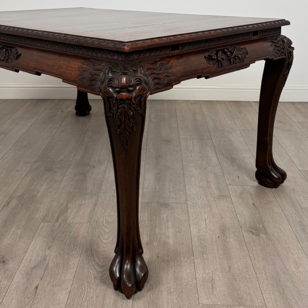 A dark carved rosewood dining suite featuring a rectangular table with carved cabriole legs accompanied by six splat-back chairs including two armchairs. View VI