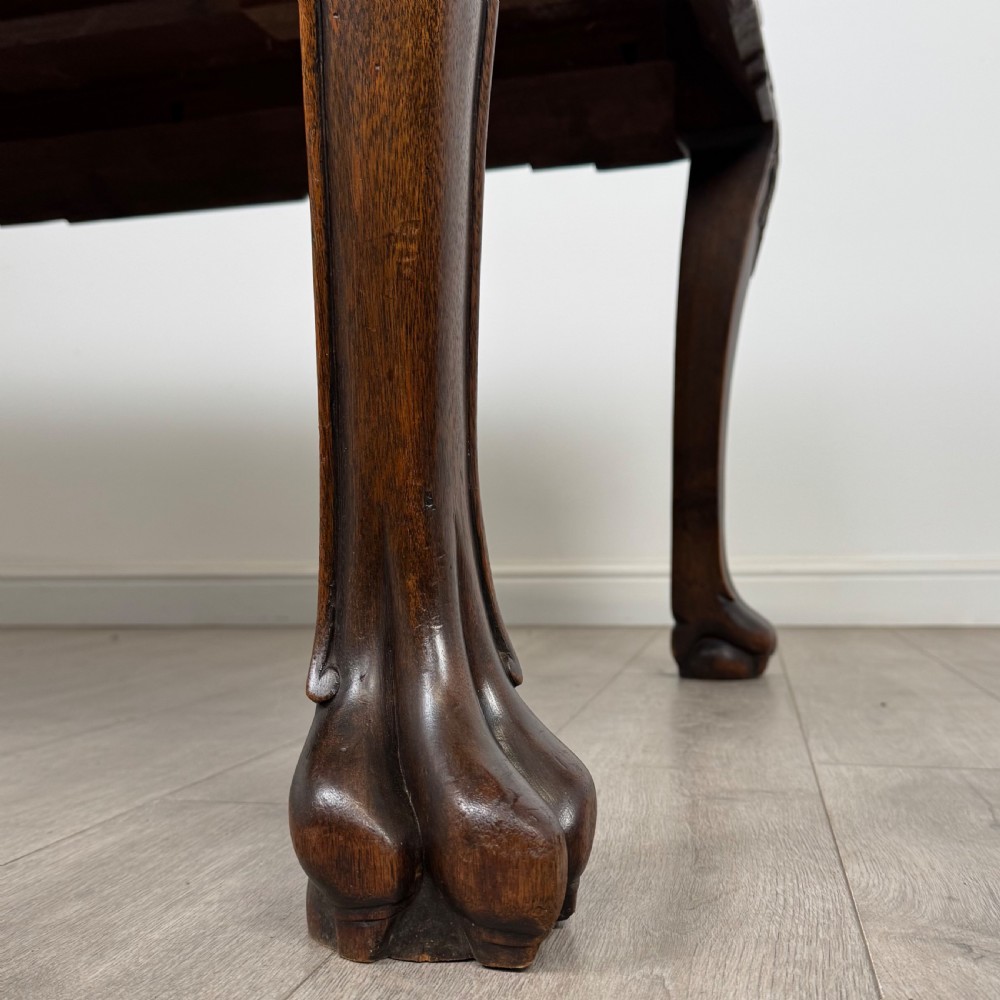 A dark carved rosewood dining suite featuring a rectangular table with carved cabriole legs accompanied by six splat-back chairs including two armchairs. View VII