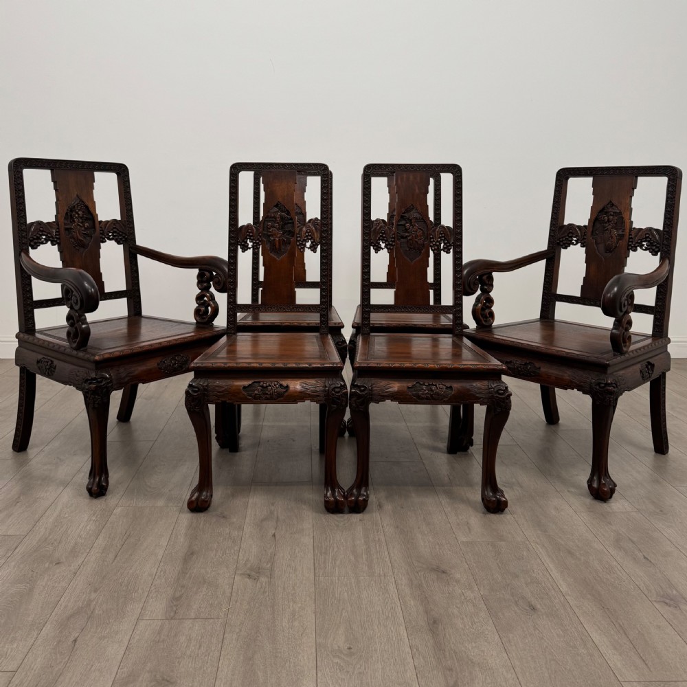 A dark carved rosewood dining suite featuring a rectangular table with carved cabriole legs accompanied by six splat-back chairs including two armchairs. View VIII
