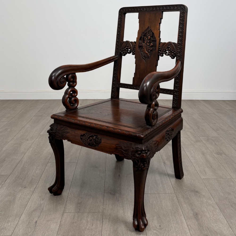 A dark carved rosewood dining suite featuring a rectangular table with carved cabriole legs accompanied by six splat-back chairs including two armchairs. View IX