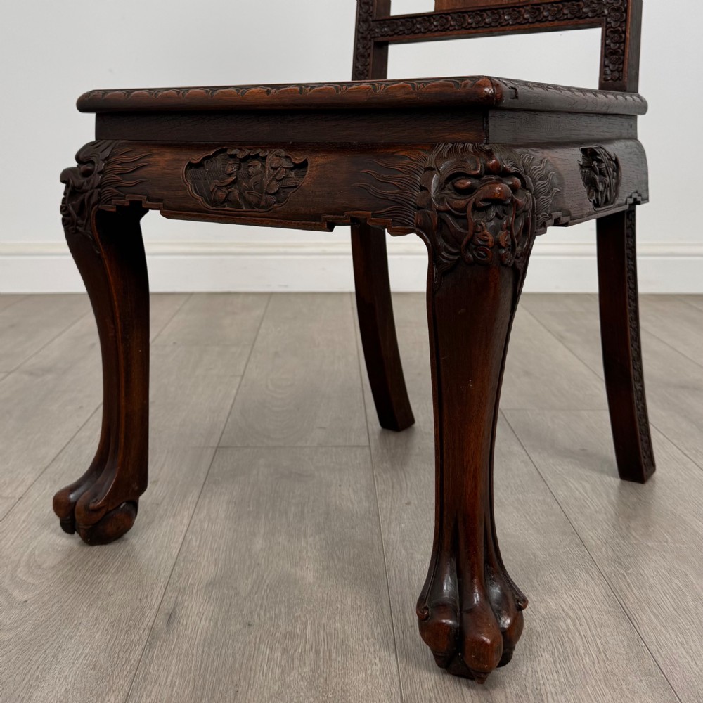 A dark carved rosewood dining suite featuring a rectangular table with carved cabriole legs accompanied by six splat-back chairs including two armchairs. View XIV